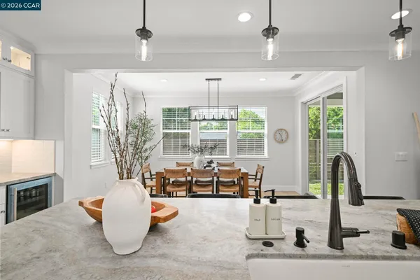 a living room with fireplace furniture and a chandelier