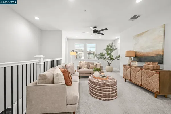 a living room with furniture a chandelier and a fireplace