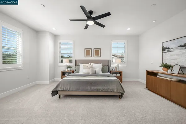 a spacious bedroom with a bed and window