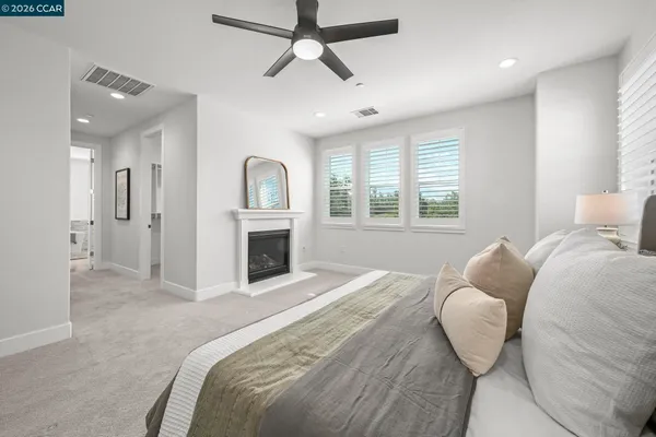 a bedroom with a bed and a fireplace