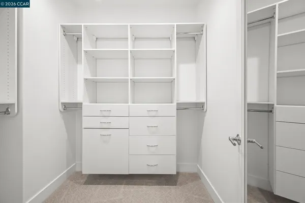 a view of walk in closet with empty racks