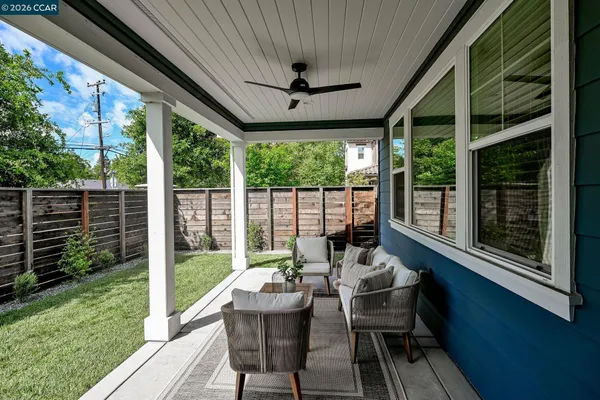 a view of a patio with couches chairs and a yard