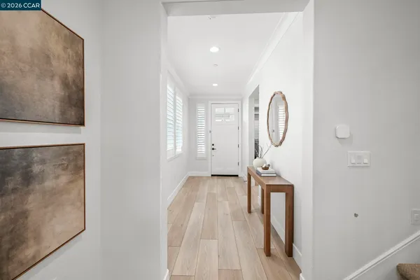 a view of a hallway with wooden floor and entryway