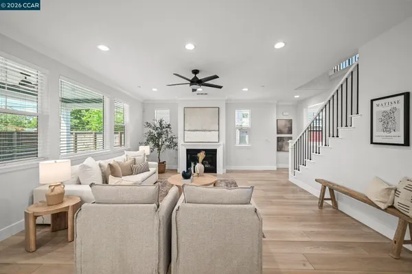 a living room with furniture a fireplace and a large window