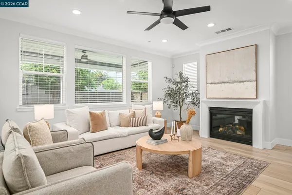 a living room with furniture a large window and a fireplace