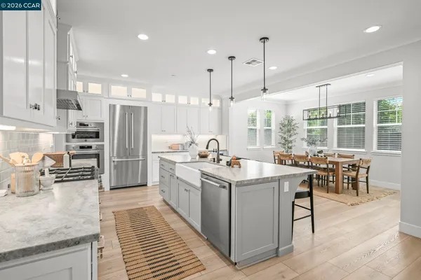 a kitchen with stainless steel appliances granite countertop a sink stove and a refrigerator