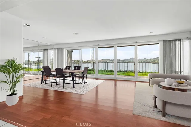 a living room with furniture and floor to ceiling windows
