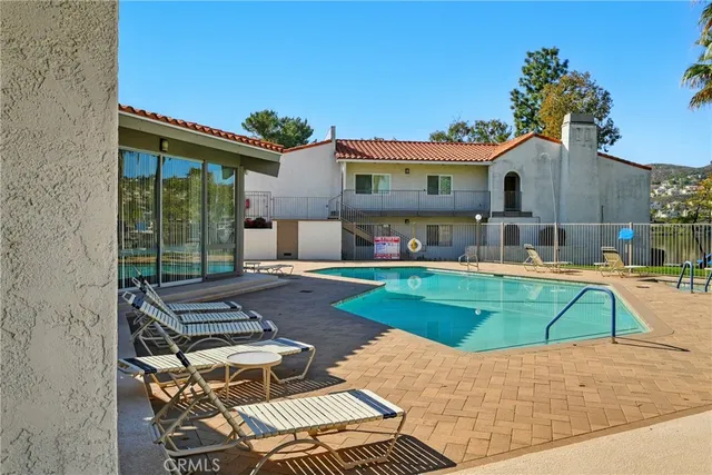 a view of a house with a yard balcony and sitting area