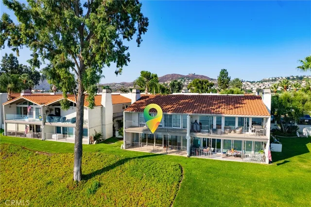 an empty room with windows and ceiling fan