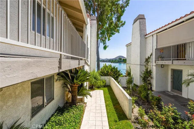 a view of a tennis ground with furniture