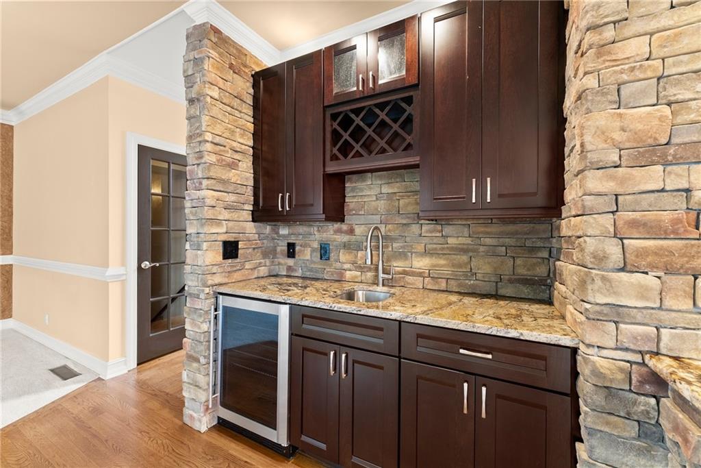 4863 Rosemoore Court Suwanee, GA 30024 - Photo 11 of 74 a kitchen with stainless steel appliances granite countertop a sink stove and cabinets