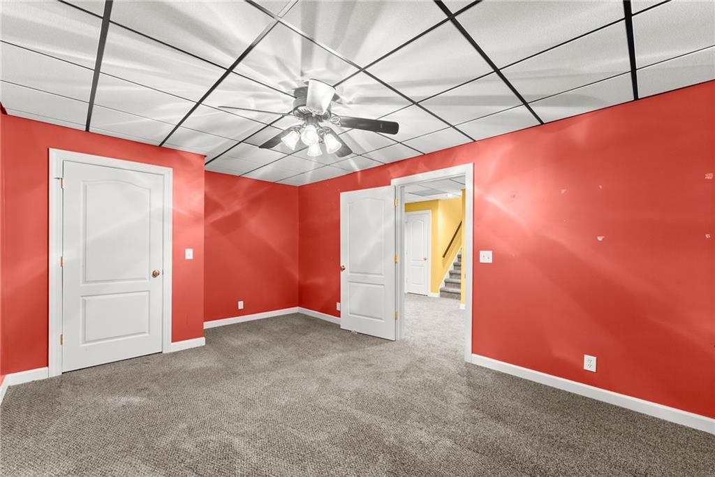 4863 Rosemoore Court Suwanee, GA 30024 - Photo 41 of 74 a view of a livingroom with a ceiling fan and window