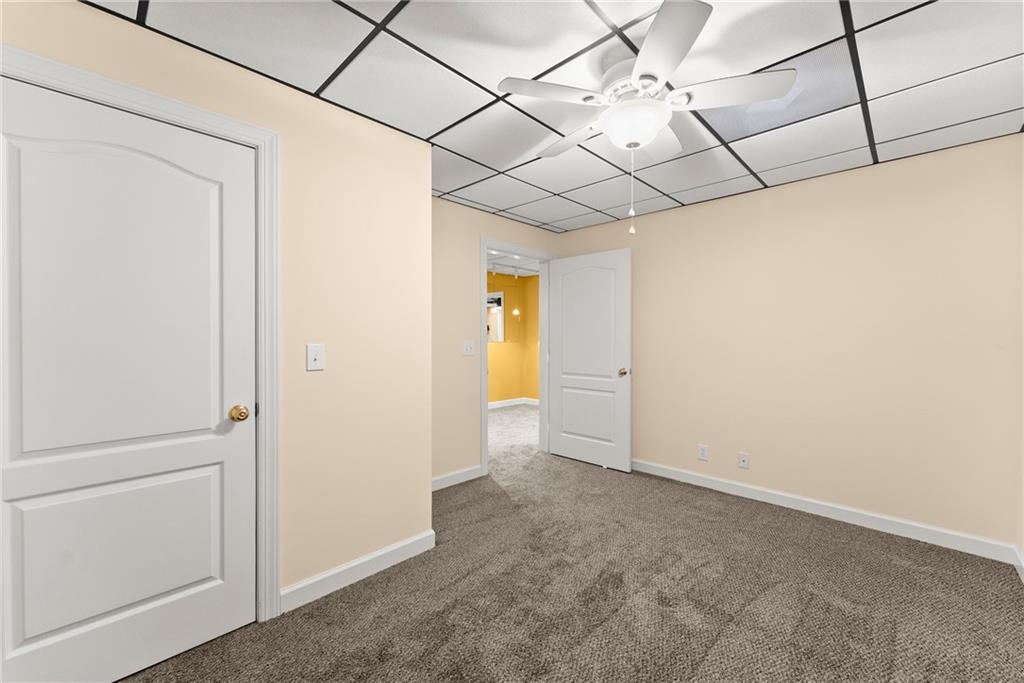 4863 Rosemoore Court Suwanee, GA 30024 - Photo 44 of 74 a view of a room with a chandelier fan and windows