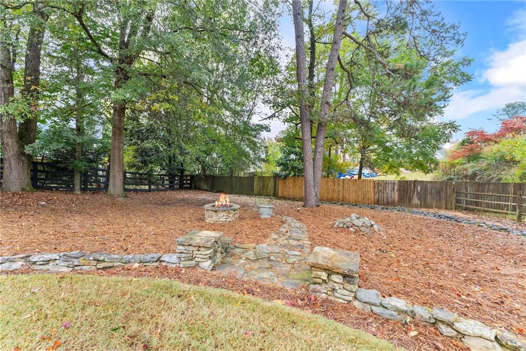 4863 Rosemoore Court Suwanee, GA 30024 - Photo 53 of 74 a backyard of a house with a trees