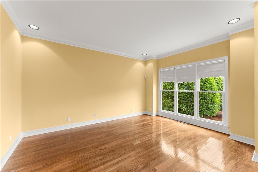 4863 Rosemoore Court Suwanee, GA 30024 - Photo 7 of 74 a view of an empty room with wooden floor and a window