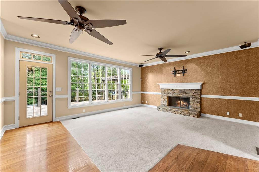 4863 Rosemoore Court Suwanee, GA 30024 - Photo 10 of 74 a view of empty room with fireplace and fan