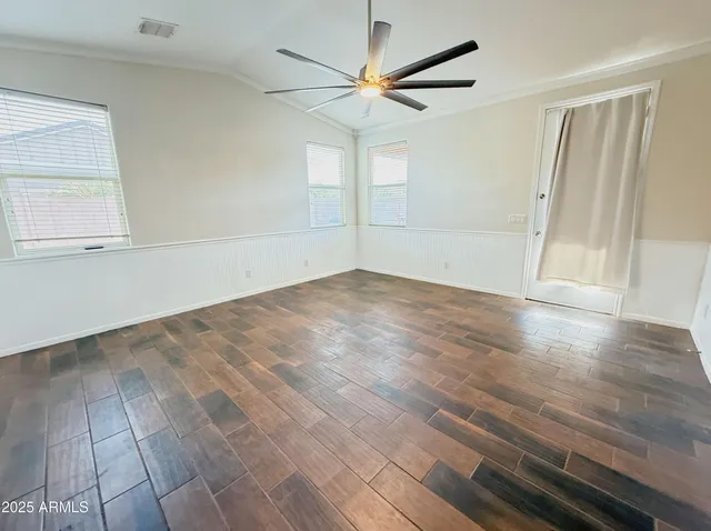 wooden floor in an empty room with a window
