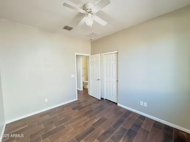 a view of an empty room with a ceiling fan