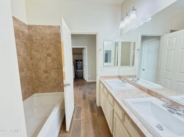 a bathroom with a granite countertop sink a bathtub and a shower