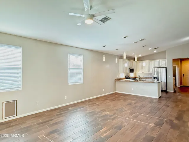 a open kitchen with stainless steel appliances kitchen island a refrigerator sink and cabinets