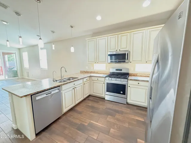 a kitchen with granite countertop white cabinets and white appliances