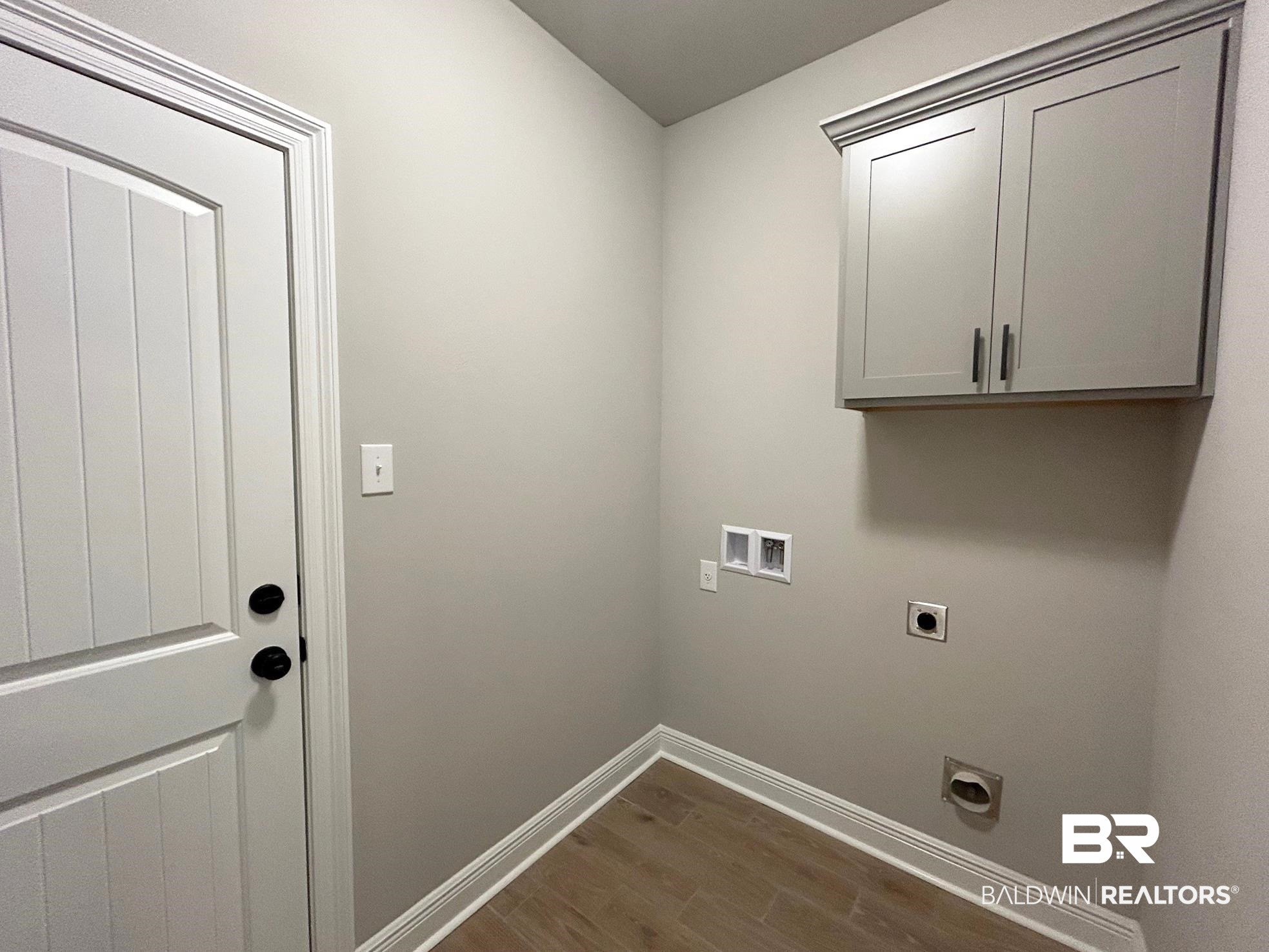 808 Sumter Loop Foley, AL 36535 - Photo 15 of 18 Laundry room with electric dryer hookup, dark hardwood / wood-style floors, cabinets, and hookup for a washing machine