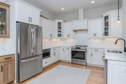 a kitchen with a refrigerator stove and sink