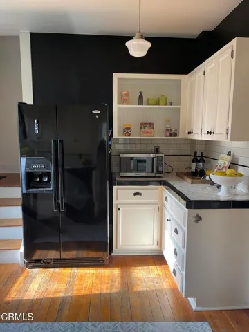 a kitchen with a refrigerator and cabinets