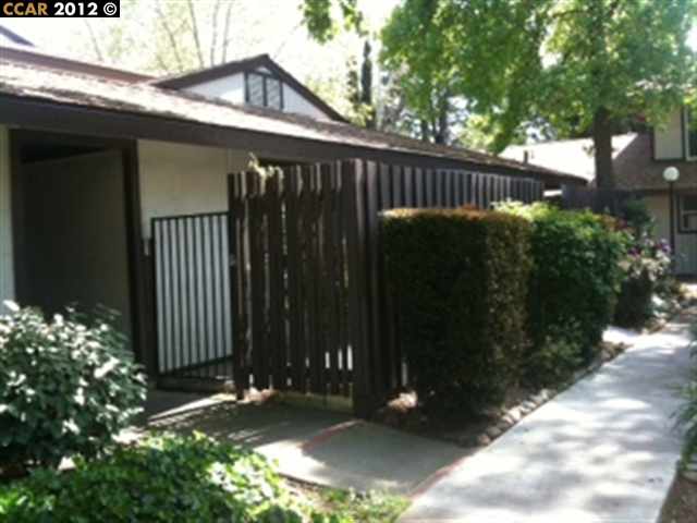 5468 Roundtree Place, Unit E Concord, CA 94521 - Photo 1 of 1 a view of street along with potted plants