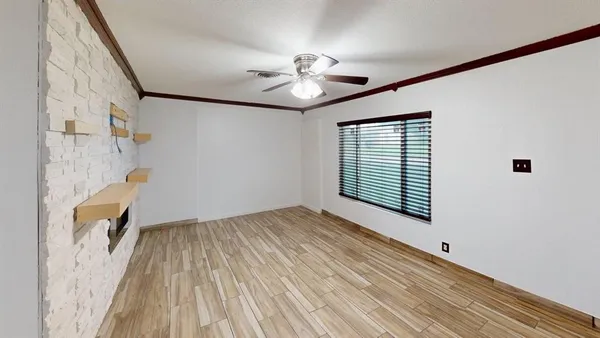a view of a livingroom with a ceiling fan and wooden floor