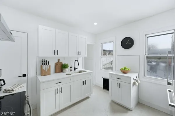 a kitchen with cabinets and window