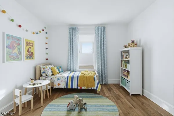a bedroom with furniture and a wooden floor