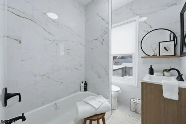 a bathroom with a sink a toilet and a mirror