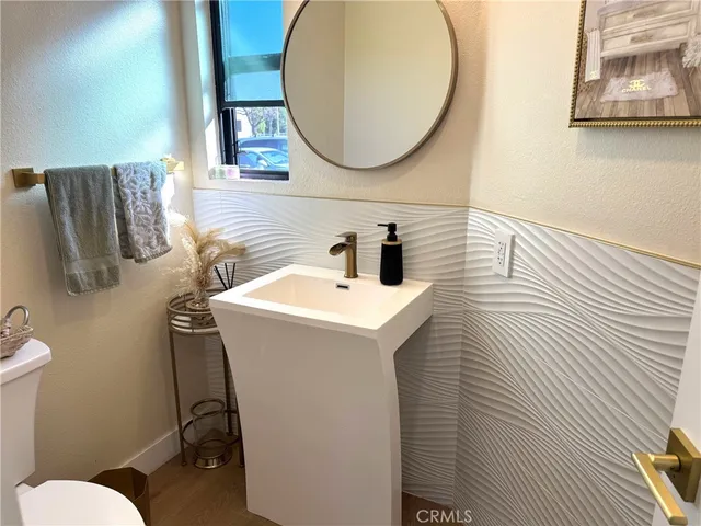 a bathroom with a sink mirror and toilet
