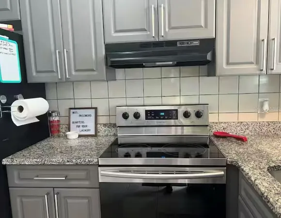 a stove top oven sitting inside of a kitchen