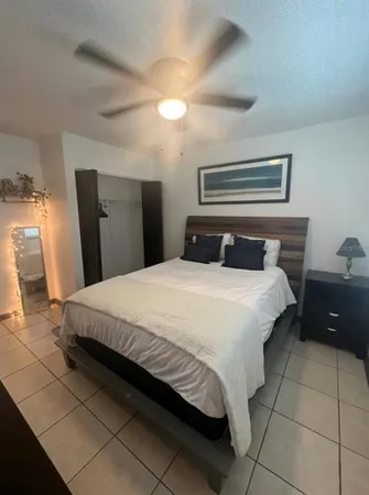 a bedroom with a bed and a lamp