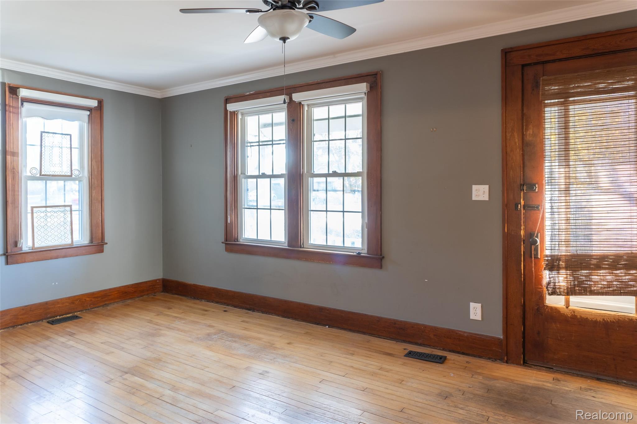 1846 North Gulley Road Dearborn, MI 48128 - Photo 5 of 32 Empty room with light wood-style floors, ornamental molding, and a ceiling fan