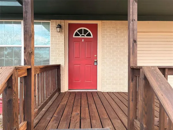 a view of a balcony with wooden floor