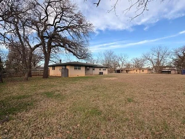 a view of large tree in front of a house