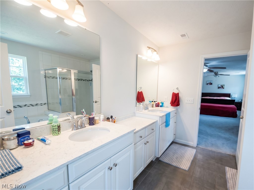 4509 Millbrook Way Akron, OH 44321 - Photo 19 of 27 Bathroom featuring dual vanities with white cabinetry and light-toned countertops