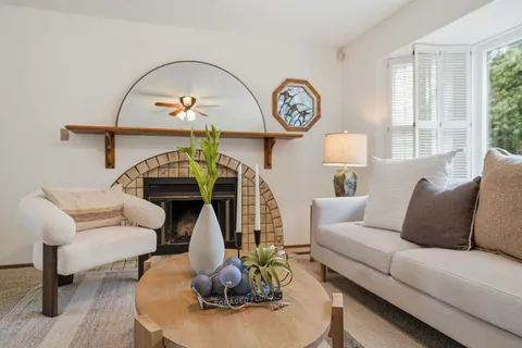 a living room with furniture a rug and a window