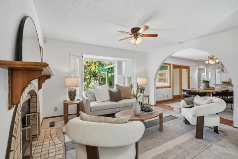 a living room with furniture a window and a chandelier