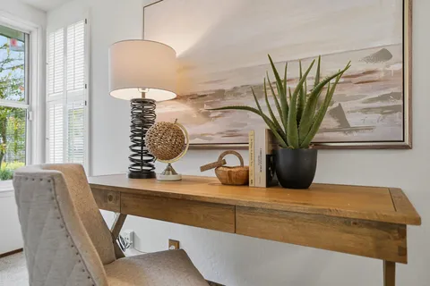 a living room with furniture and a potted plant