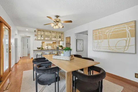a view of a dining room with furniture and wooden floor
