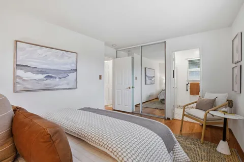 a bedroom with a bed and a couch