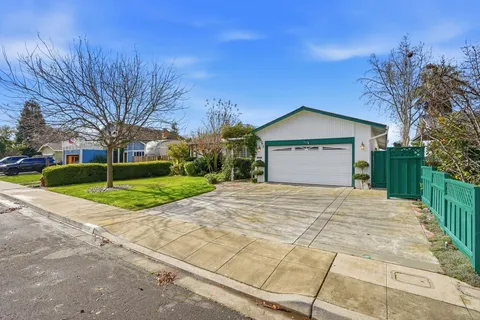 a view of backyard of house with garage and a yard