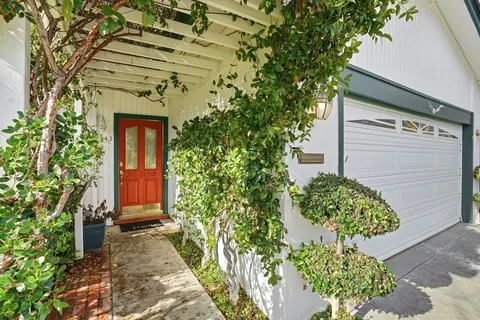 a front view of a house with garden