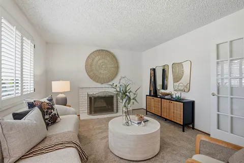 a living room with furniture a fireplace and a flat screen tv