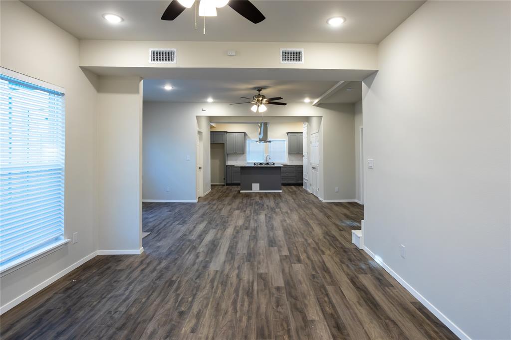 4522 Reiger Avenue Dallas, TX 75246 - Photo 13 of 37 Unfurnished living room with sink, ceiling fan, and dark hardwood / wood-style flooring