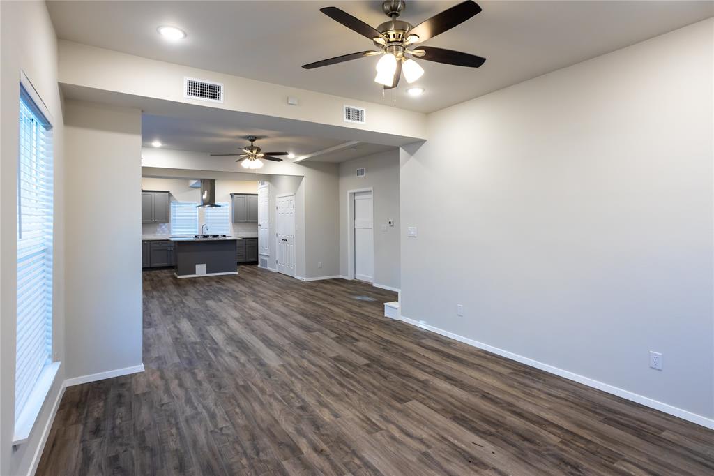 4522 Reiger Avenue Dallas, TX 75246 - Photo 14 of 37 Unfurnished living room featuring sink, dark hardwood / wood-style floors, and ceiling fan